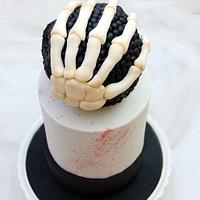 Skull cake and skeleton hand.