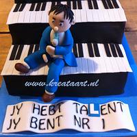 man's cake. For an owner of a driving school who also plays keyboard and sings in a band.