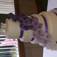 four tiered wedding cake with purple roses and bride and groom handmade topper (with karate theme) x