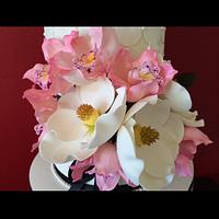 Pink orchids and magnolias wedding cake