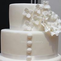White wedding cake based on Justin Alexander dress