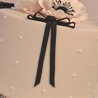 Pink Anemones with fondant black bows.