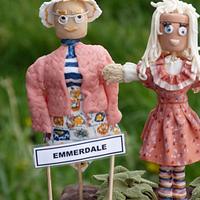 Emmerdale Scarecrows looking after a mud cake (of course!)