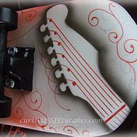 Skull and guitar skateboard cake