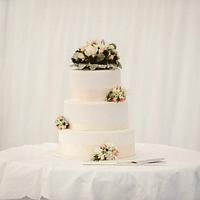 Simple three tier wedding cake with fresh flowers