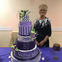 Purple six tier 80th birthday cake