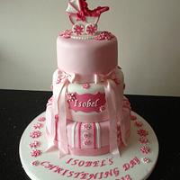 pink christening cake with pram topper