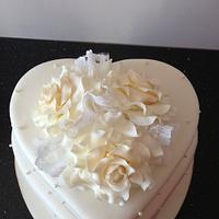 heart shaped wedding cake with roses and lace