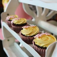 Yellow and pink themed cake and cupcakes