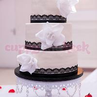Romantic wedding cake with lace and roses