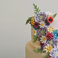Meadow flowers and peonies wedding cake