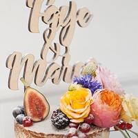 Semi-naked wedding cake with fruit and flowers