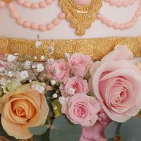 Oppulent gold and peach wedding cake