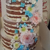 3 tier naked wedding cake with sugar flowers.