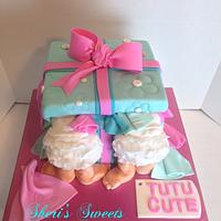 Babies in a present cake