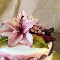 Purple cake with lily and roses.