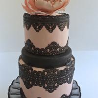 pink fondant cake with black lace