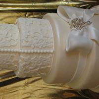 Lace and bow wedding cake