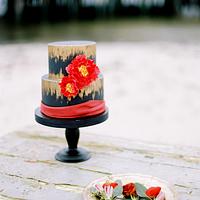 Wedding cake in black, gold and red.